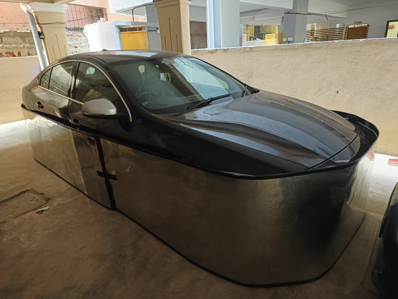 Car-lungi installed on silver Tata Harrier in apartment basement parking at night - AP number plate